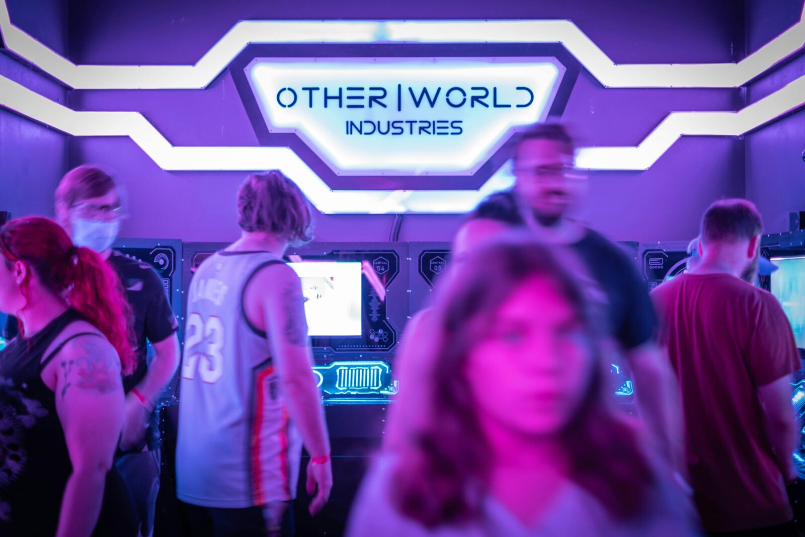 People enjoying games at a neon-lit arcade, capturing the energetic and futuristic vibe.